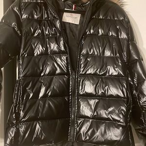 Moncler for sell. This shiny black jacket is a good show stopper!
